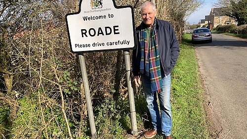 Steve Shellabear standing outside roadside Roade sign