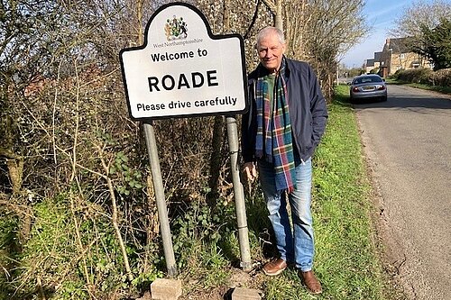 Steve Shellabear standing outside roadside Roade sign